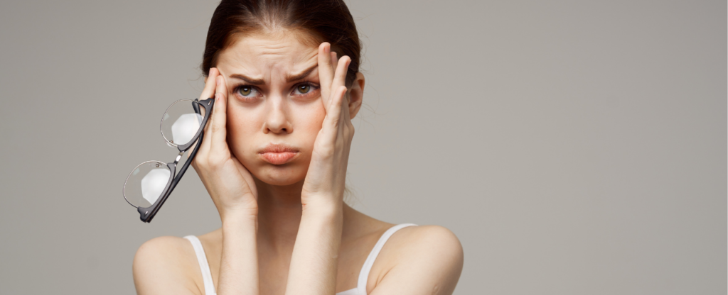 fond gris fille qui souffle et se tient la tête