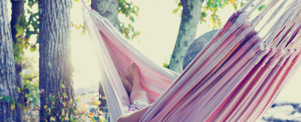 soleil arbres femme qui se détend dans un hamac